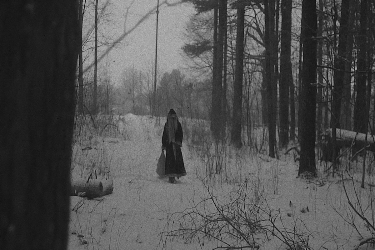 Still from Krampus the Christmas Devil;  A figure in red Santa robes walks through a snowy forest