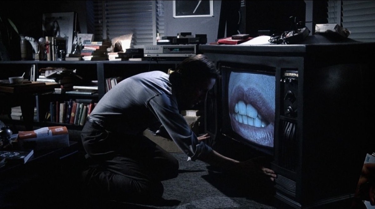 the cableway max stares at a mouth on a tv screen in "Videodrome" 