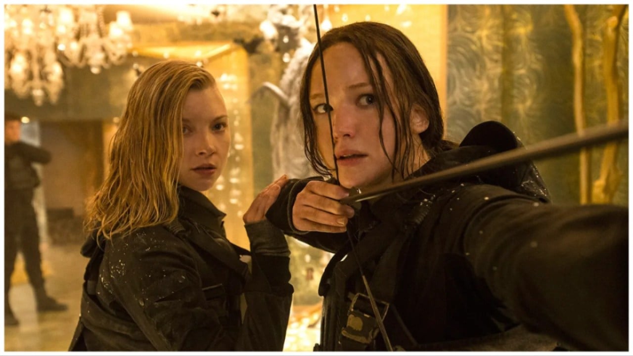 Cressida (Natalie Dormer) and Katniss (Jennifer Lawrence) standing close as Katniss draws her bow from 'The Hunger Games: Mockingjay Part 2'.