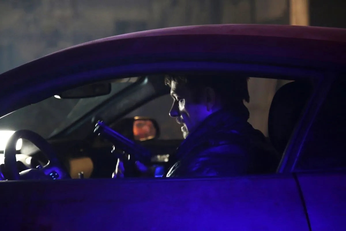Godlock loading his weapons in a car in 'Silent Night'.