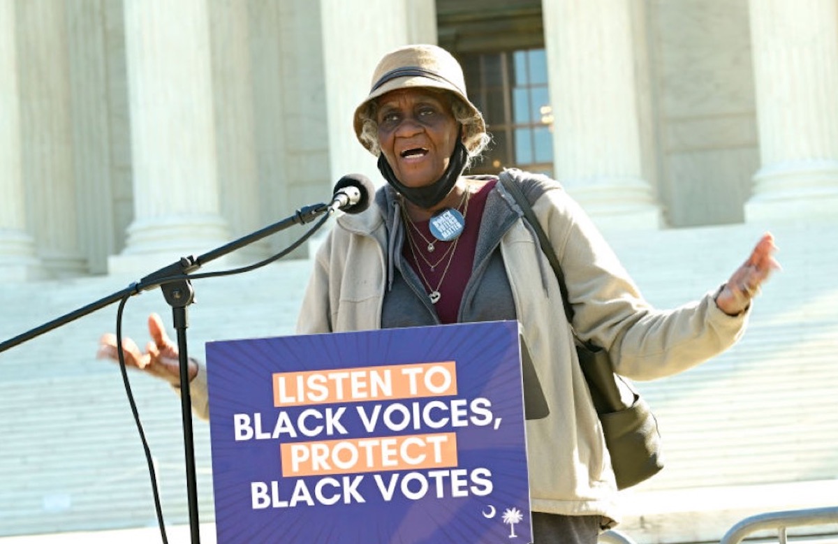 WASHINGTON, DC - OCTOBER 11: Emma Brooks sings at a rally outside of the U.S. Supreme Court on October 11, 2023 in Washington, DC. South Carolina voters and Civil Rights are calling on SCOTUS to protect Black voters in the Alexander V. SC State Conference of the NAACP court case.