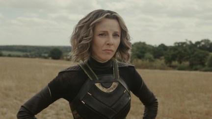 Sylvie stands with her hands on her hips in a field. She's still wearing her clothes from Loki season 1.