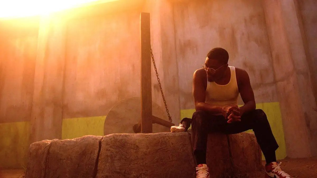Joe (Lil Rel Howery) sits on the edge of the millstone in The Mill.