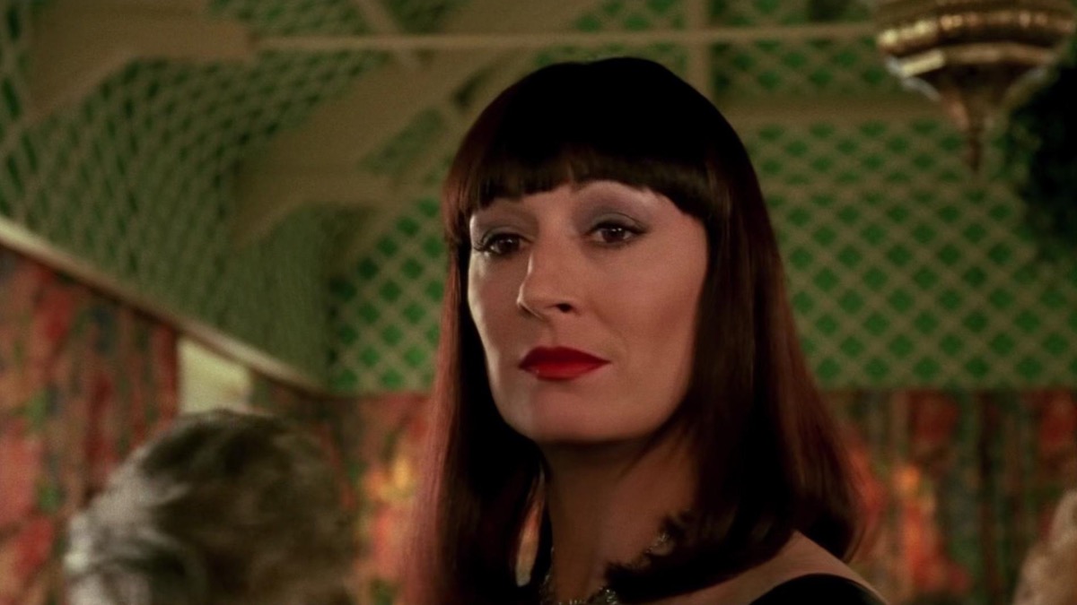 A spooky woman (Anjelica Huston) gives a knowing gaze to someone offscreen in "The Witches".