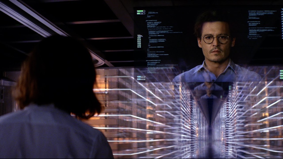 A man on computer screen floats above cyberspace while a woman looks on in "Transcendence" 