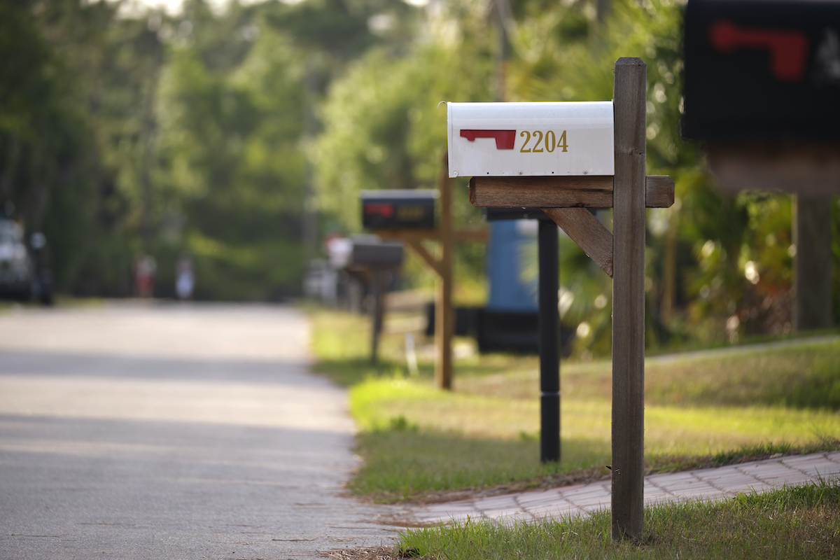 A line of mailboxes on a suburban street.