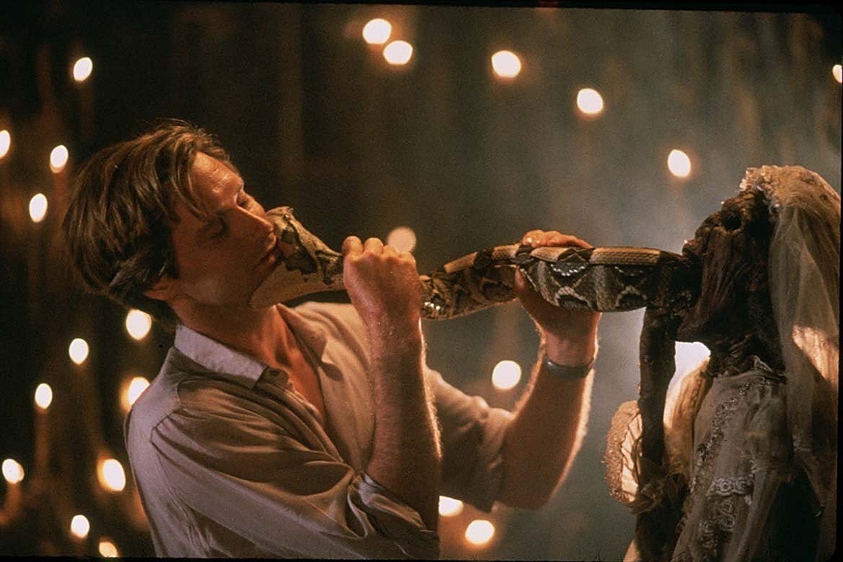 A snake bites Bill Pullman as Dennis Allan in 'The Serpent and the Rainbow' (1988)