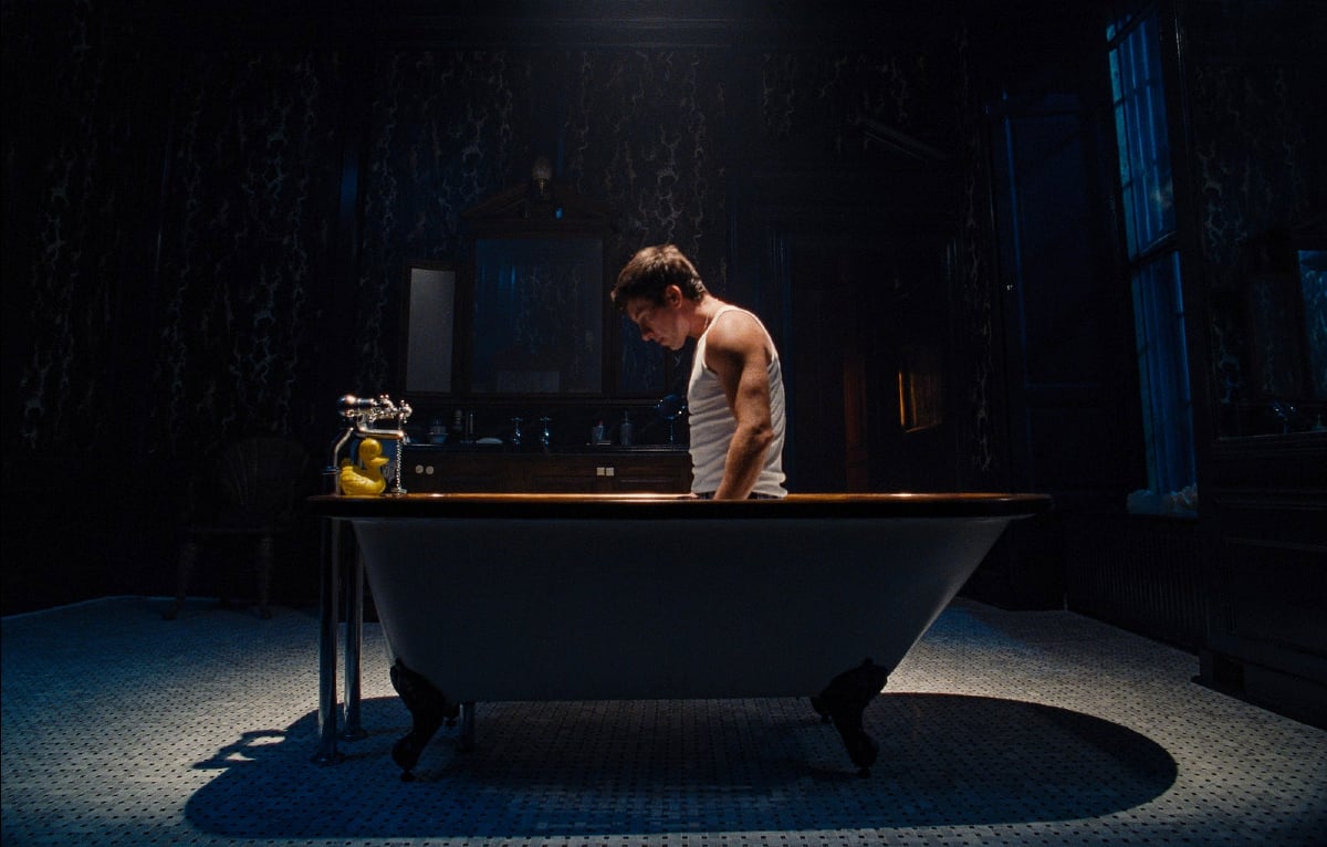 Barry Keoghan kneels in a bathtub in 'Saltburn'