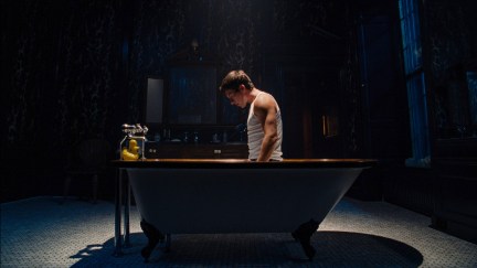 Barry Keoghan kneels in a bathtub in 'Saltburn'