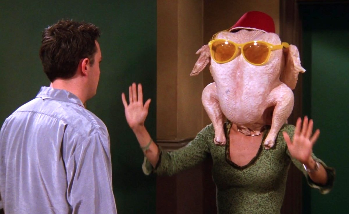 Courtney Cox as Monica, a woman wears a raw turkey on her head in 'Friends.'