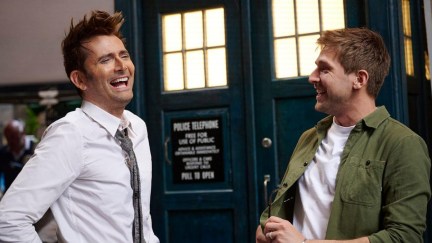 David Tenant and Steffan Powell standing in front of the Tardis in a promo image for Doctor Who: Unleashed