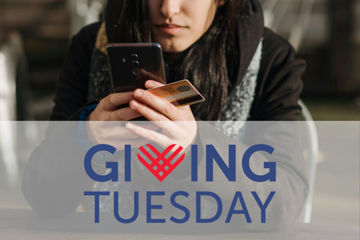 Brown woman holding credit card and phone over the logo for Giving Tuesday. 