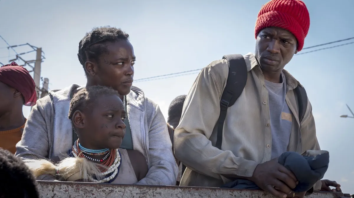 3 refugees with worried expressions on their face in "His House" movie
