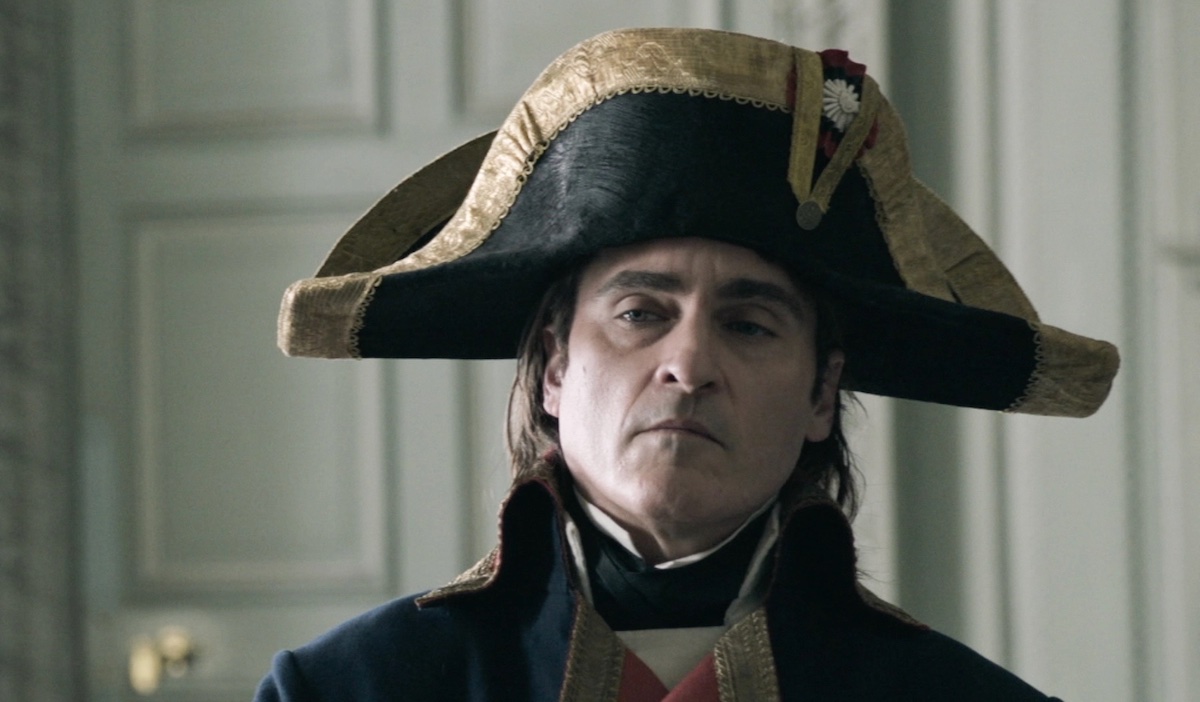 Napoleon (Jaoquin Phoenix) glares at someone while wearing his iconic bicorne hat.