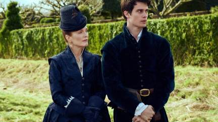 Julianne Moore and Nicholas Galitzine, an older white woman walks in a garden with a younger white man in period clothes in 'Mary and George.'