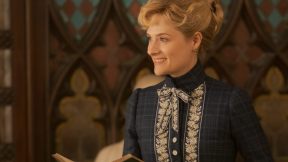 Louisa Jacobson as Marian Brook, a woman smiles while holding a book in 'The Gilded Age.'