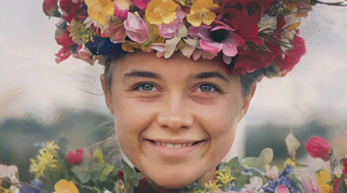Image of Florence Pugh as Dani in a scene from the film 'Midsommar.' She is a white woman wearing a thick crown of multicolored flowers and up to her neck in a mountain of flowers fashioned like a dress. This is a close-up of her face where she's smiling insanely.
