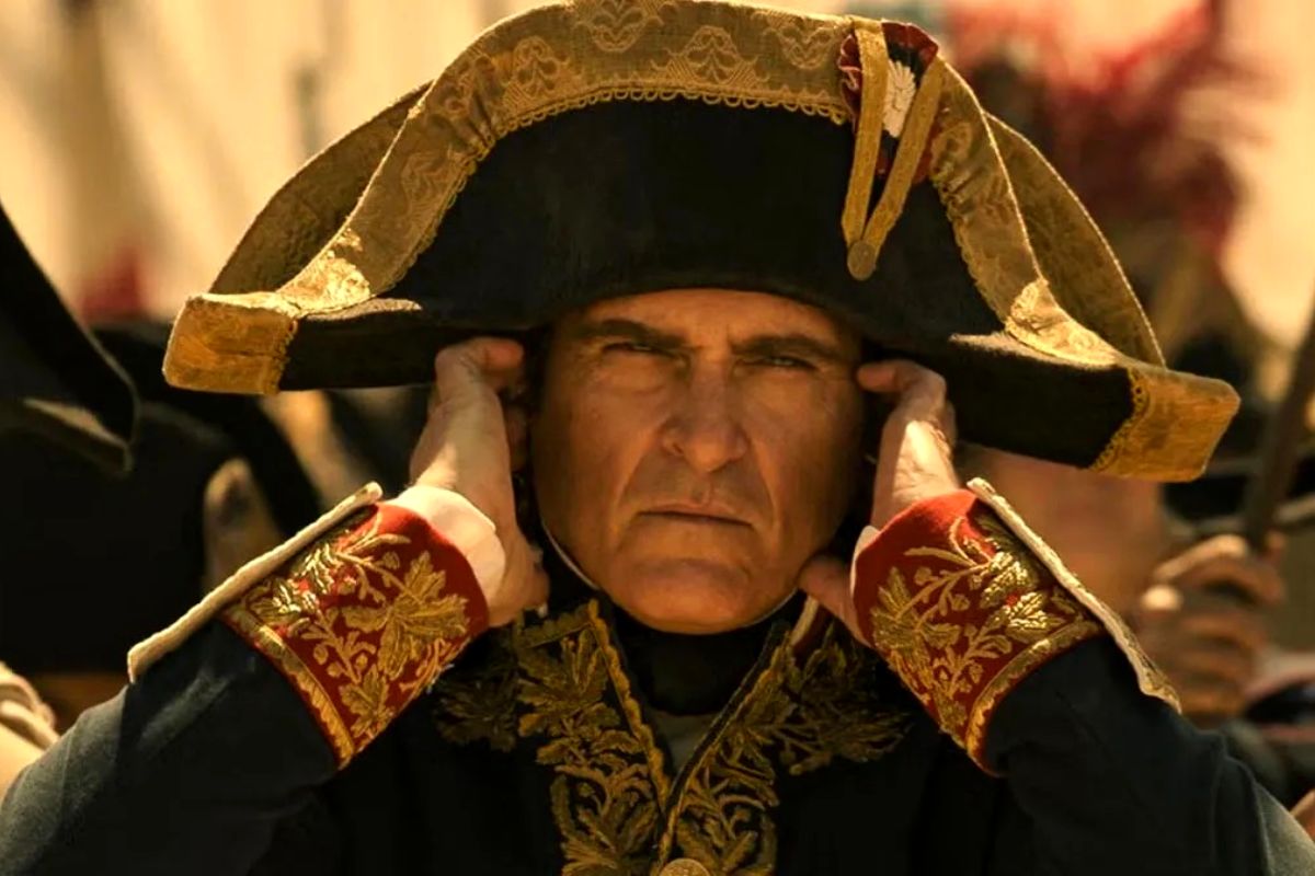French Emperor Napoleon Bonaparte (Joaquin Phoenix) covering his ears. 