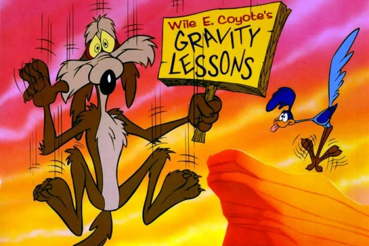The animated Wile E. Coyote falls off a cliff holding a sign while the Road Runner looks on in 'Looney Tunes.'
