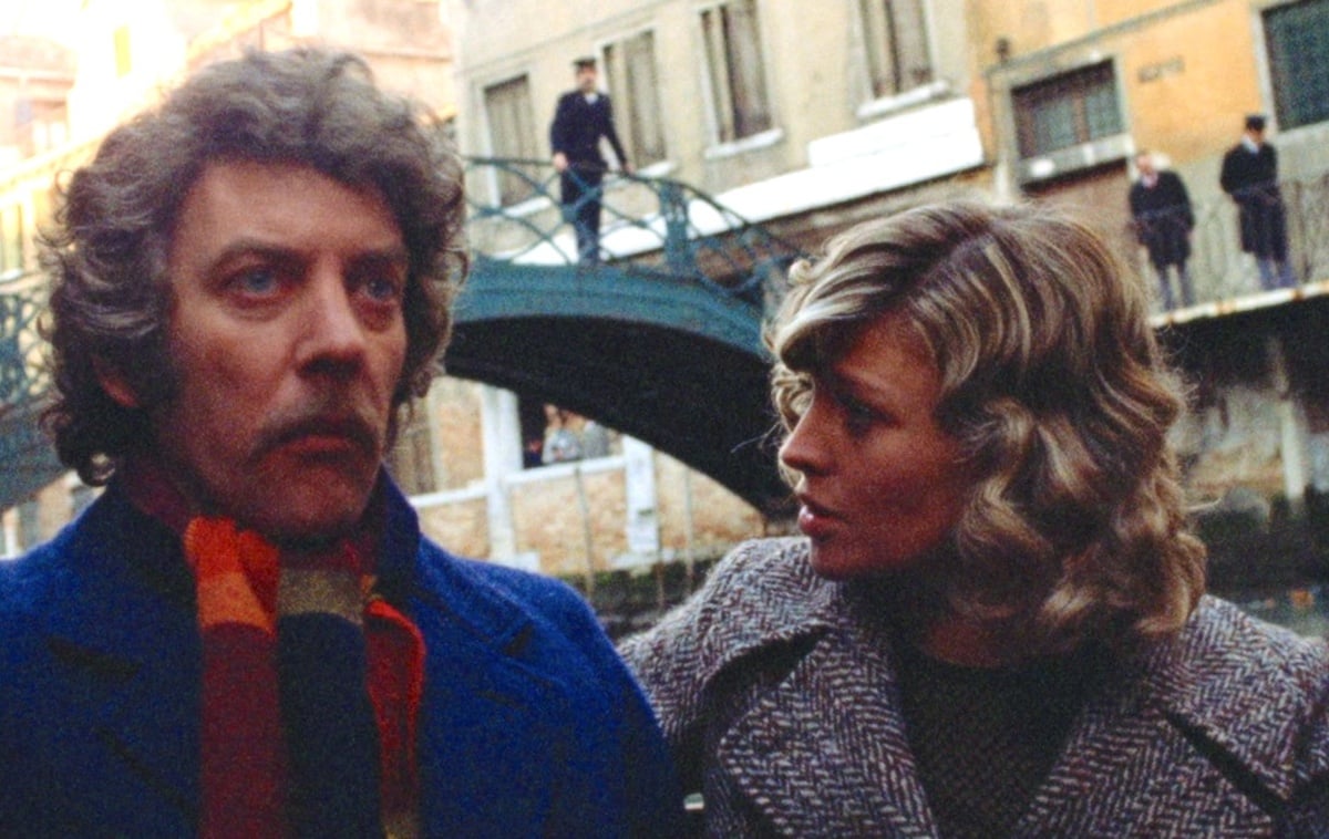 Donald Sutherland and Julie Christie next to a bridge in Venice in 'Don't Look Now'