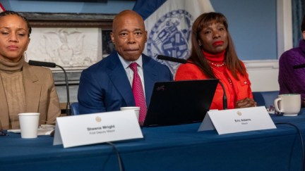 NYC mayor Eric Adams sitting on a panel.