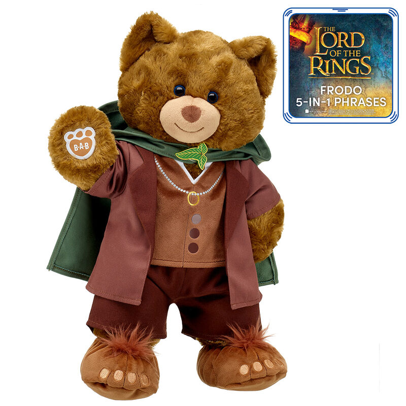 A brown bear with a friendly expression in a green and brown medieval style outfit. He's stood up and extending a paw.