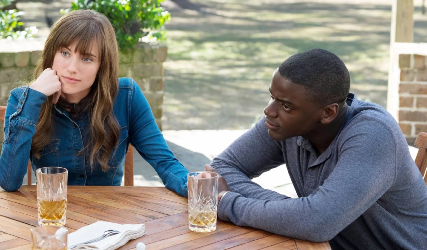Allison Williams and Daniel Kaluuya sit together in a scene from 'Get Out'
