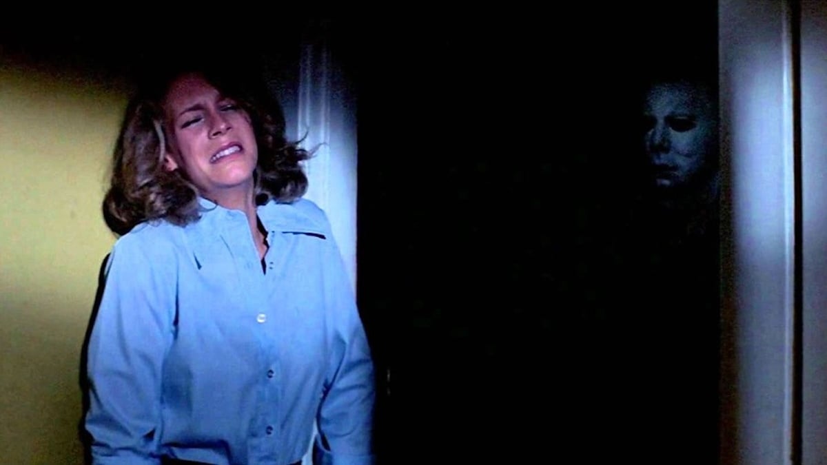 Jamie Lee Curtis as Laurie Strode hides from Mike Myers in 'Halloween'