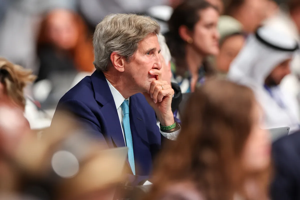 John Kerry listens intently during a climate conference.