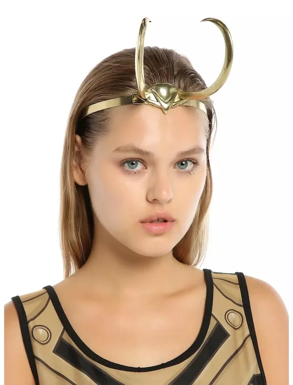A young woman wears a small set of golden Loki-style horns.