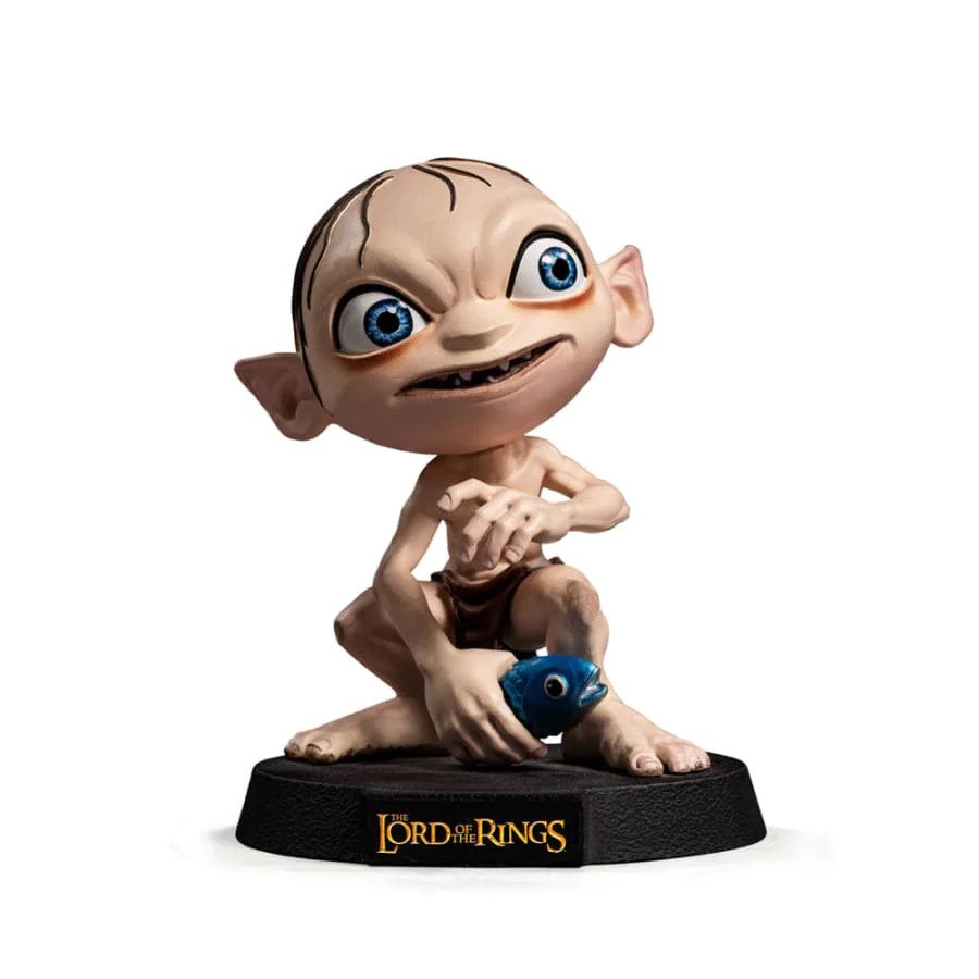 A large headed, cartoon version of Gollum, making a wretched face as he's crouched holding a fish.