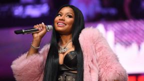 Nicki Minaj smiles coyly while performing