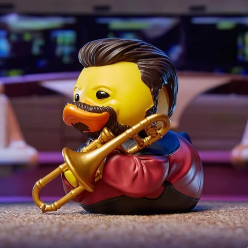 A rubber duck made to look like Commander Riker. He has hair and a beard, a uniform, and a little trombone