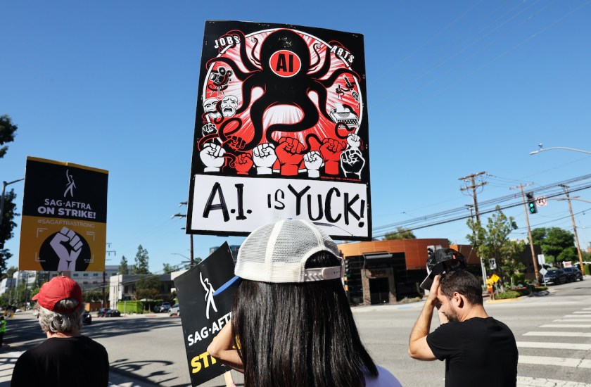 On a SAG-AFTRA picket line, one sign reads "AI is yuck!"