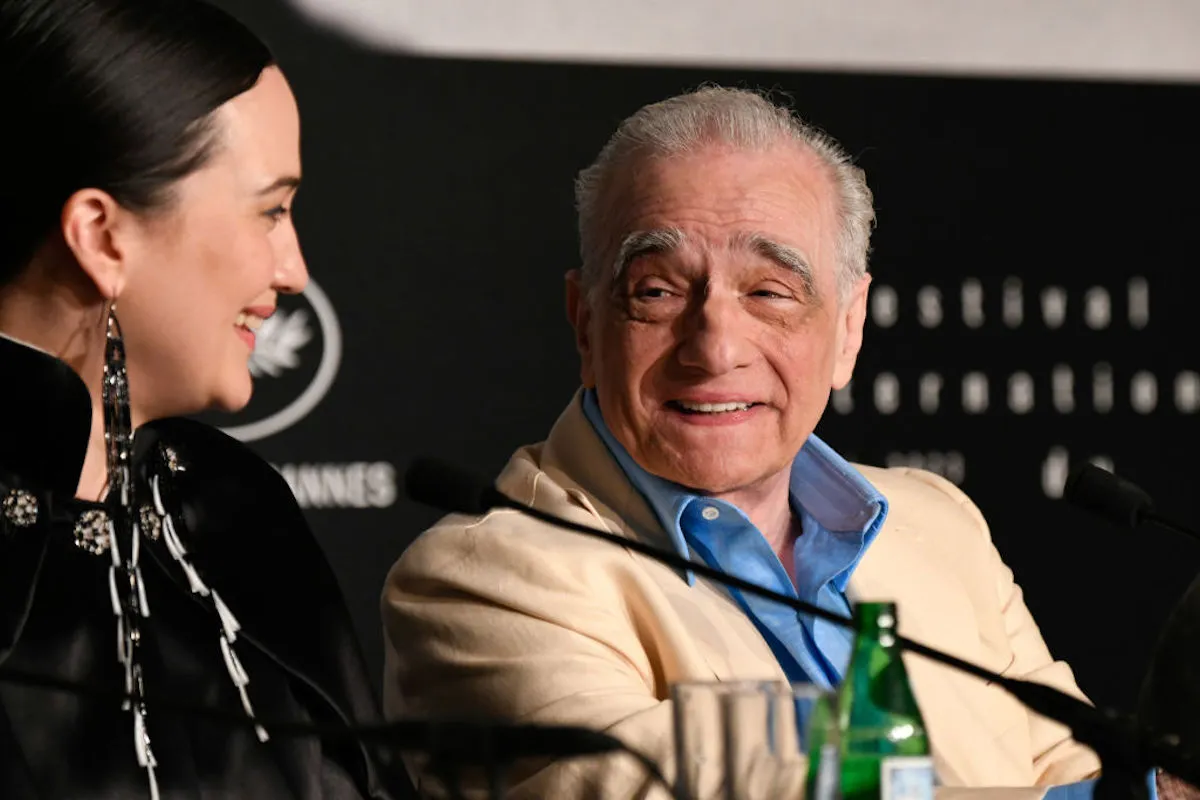 Martin Scorcese and Lily Gladstone smile at each other during a film festival press conference.