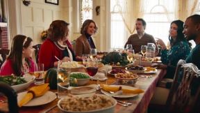 A family gathers around a table for Thanksgiving dinner in an SNL sketch