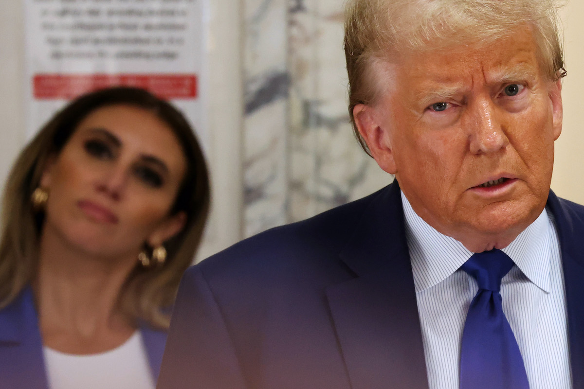 Donald Trump glares as his lawyer Alina Baba stares vacantly behind him.