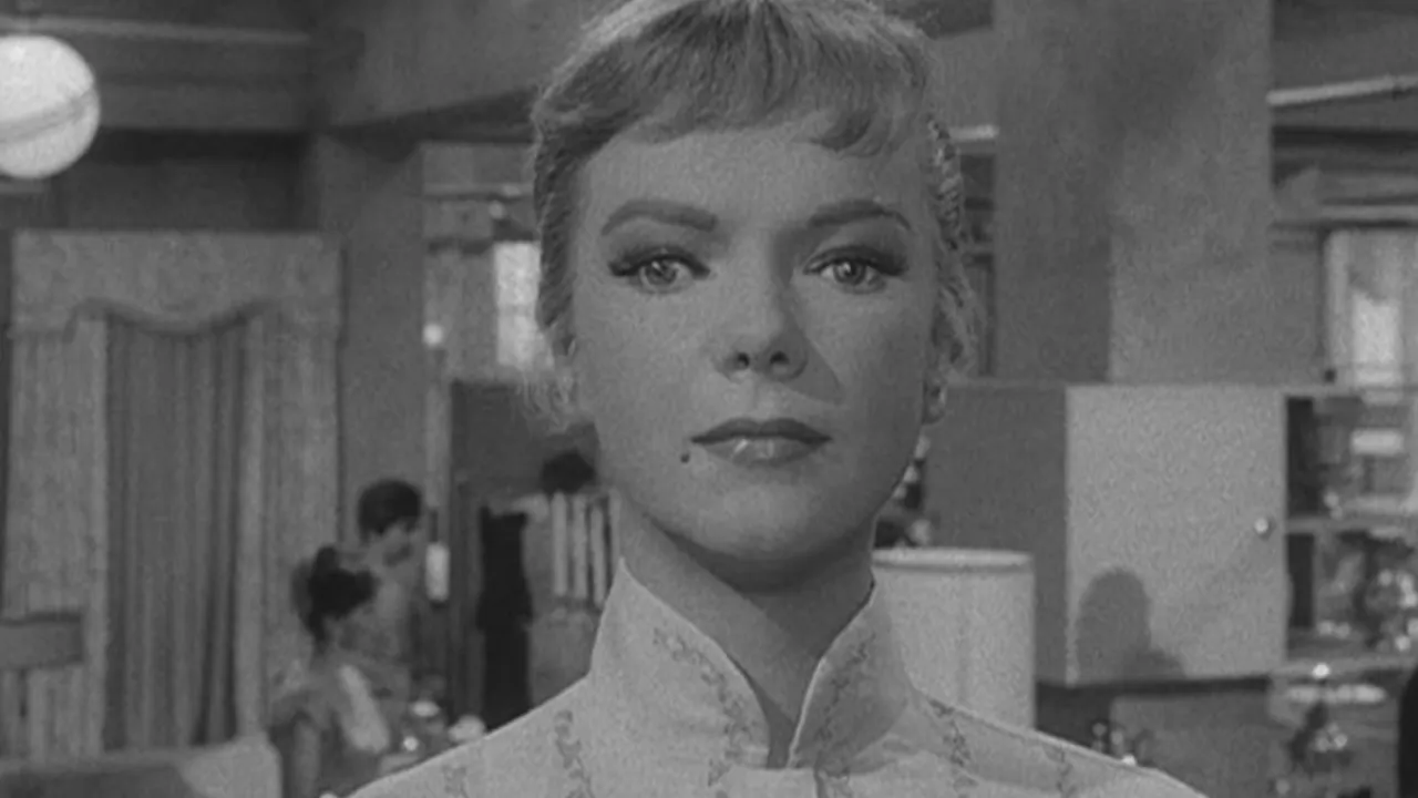 A young blonde woman stands still in a scene from The Twilight Zone.