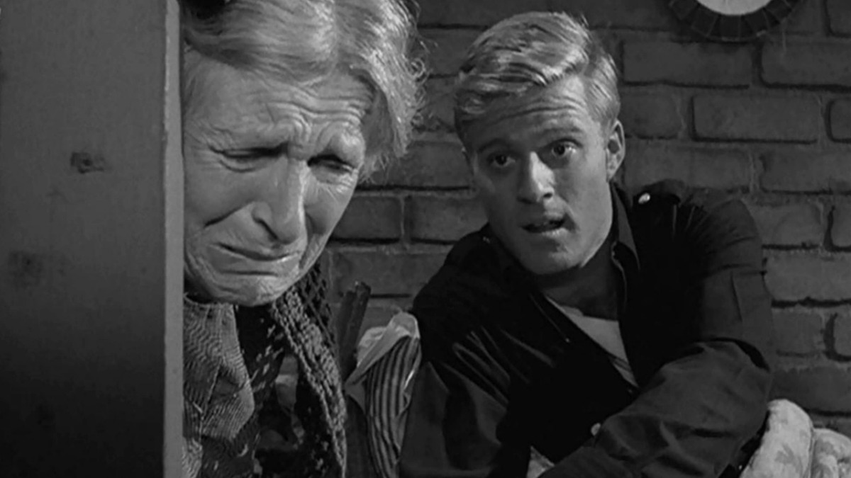 A young handsome man and a crying older woman seen in the Twilight Zone episode Nothing in the Dark