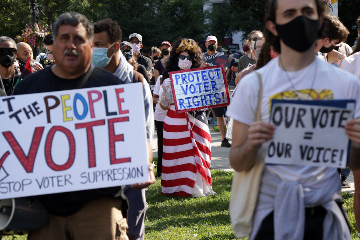 A crowd of protesters rallying for voting rights.