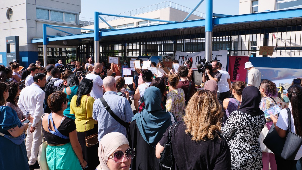 A crowd protests France's school ban on abayas