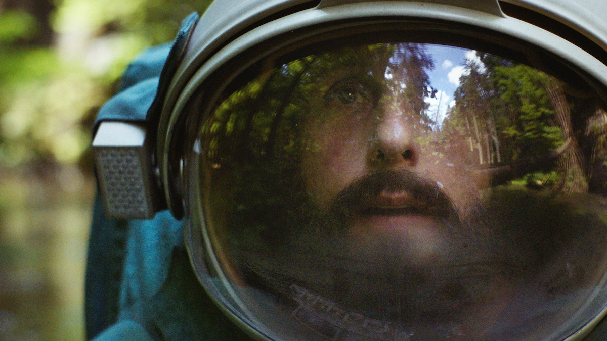 Adam Sandler wearing an astronaut helmet in Spaceman