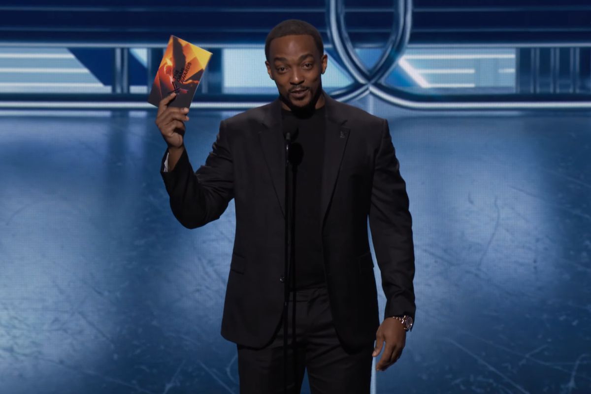 Anthony Mackie on stage holding up the winner envelope at The Game Awards 2023.