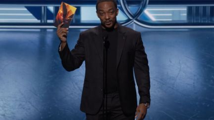 Anthony Mackie on stage holding up the winner envelope at The Game Awards 2023.