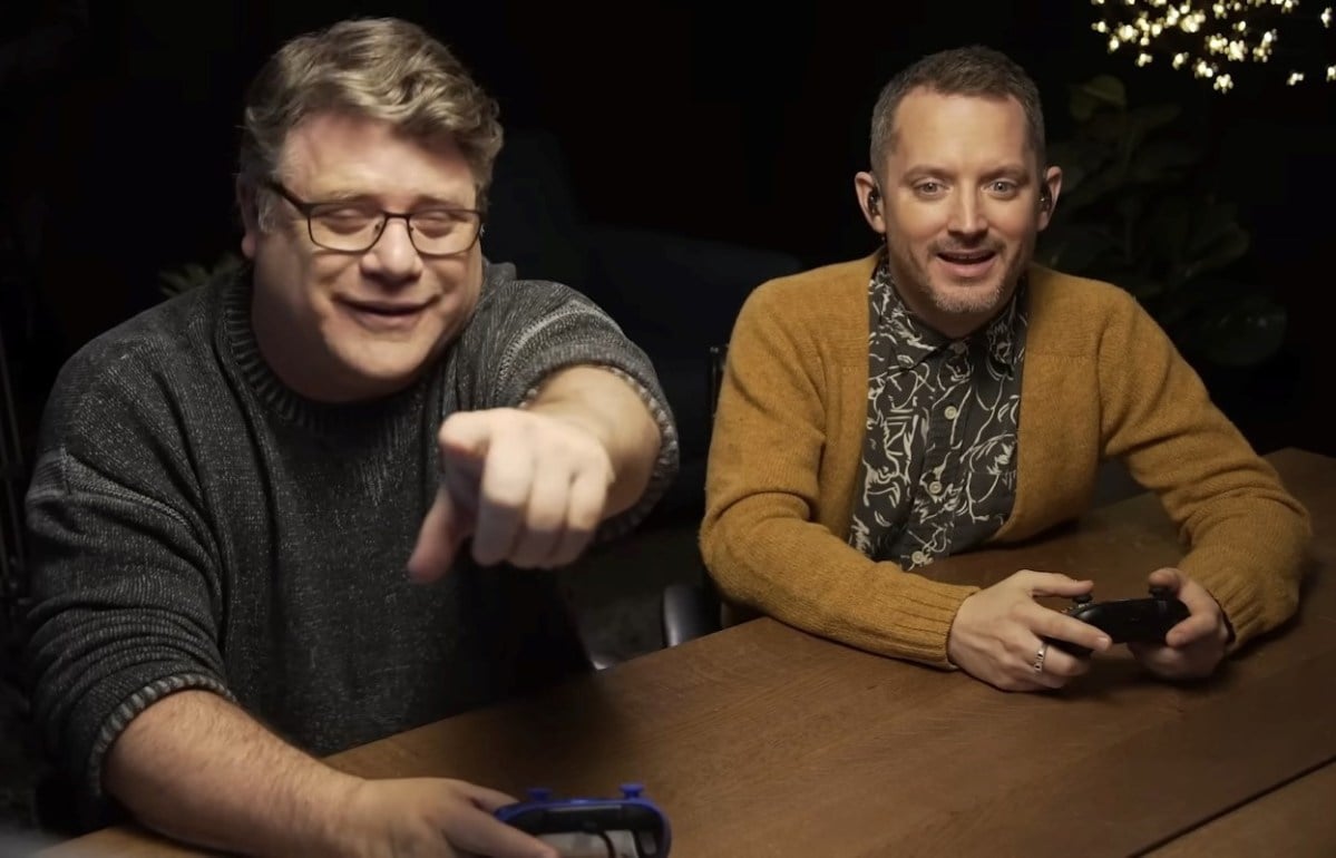 Sean Astin pointing at what Elijah Wood while they and Swen Vincke play the first act of Baldur's Gate 3.'