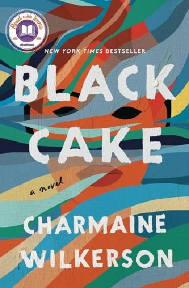 The cover of the novel 'Black Cake' by Charmaine Wilkerson. The title and author's name are in large white letters over a multi-colored background in which we can see the abstract image of a woman's face. 
