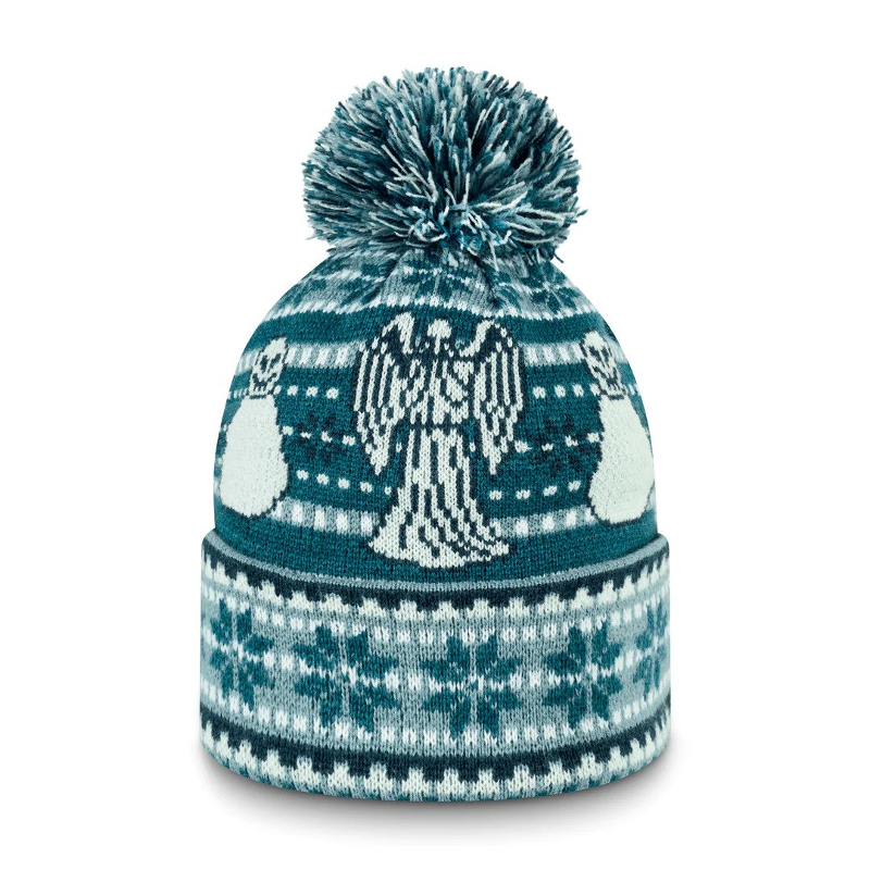 A blue and white bobble hat with snowflakes, weeping angels and snowmen on it in a fair isle pattern.