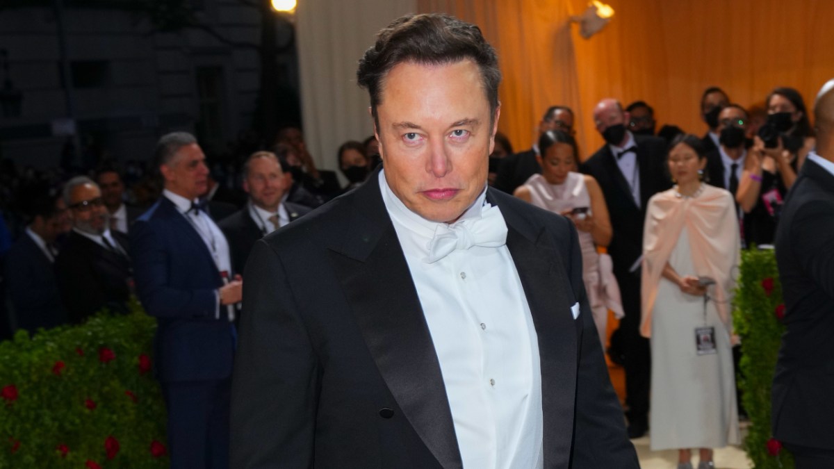 Elon Musk looking unhappy while he gets his picture taken at the 2022 Met Gala.