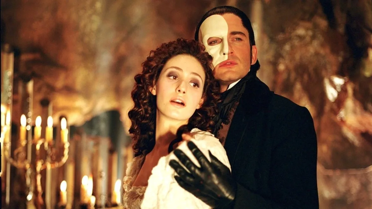 Christine and the Phantom hold each other in 'The Phantom of the Opera' movie.