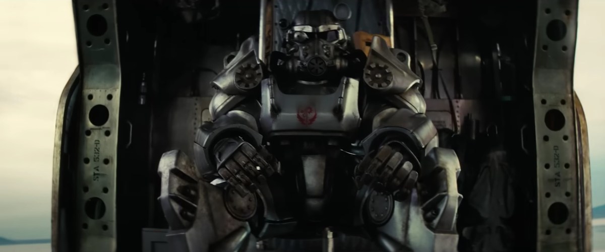 Screencap of someone in Brotherhood of Steel armor in the 'Fallout' show. They are sitting in a Vertibird.